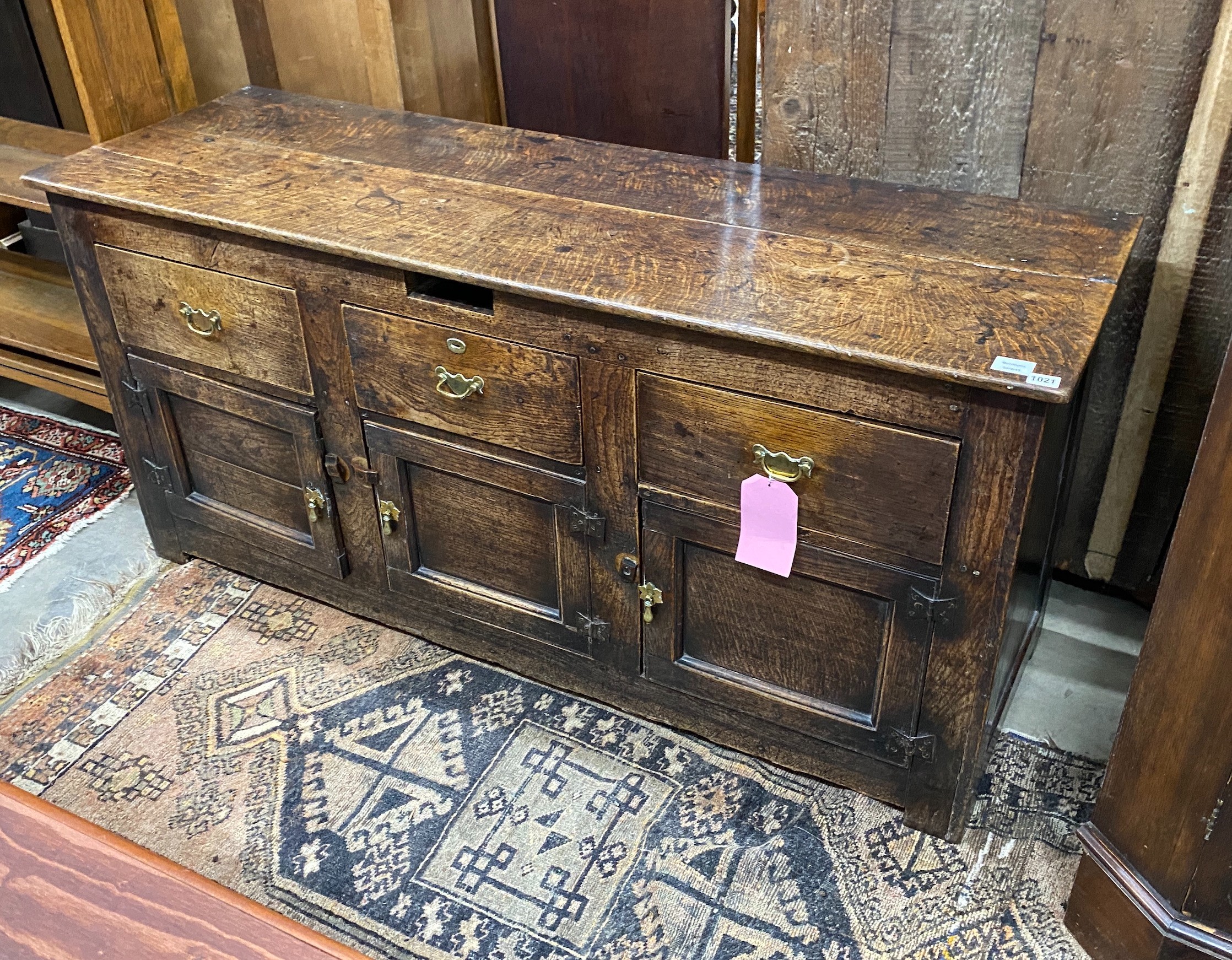 A late 18th century oak low dresser, the frieze with a small later added drawer, length 157cm, depth 52cm, height 75cm